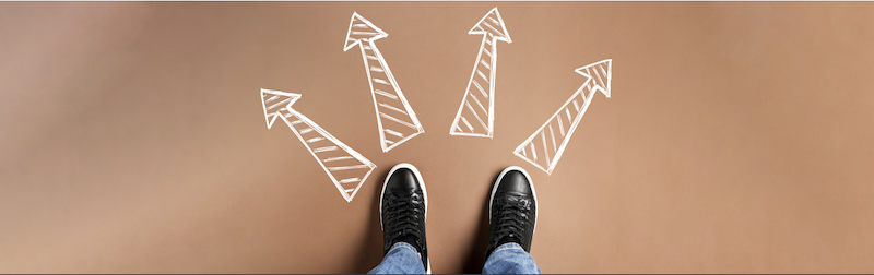 Feet with four chalk arrows to choose direction