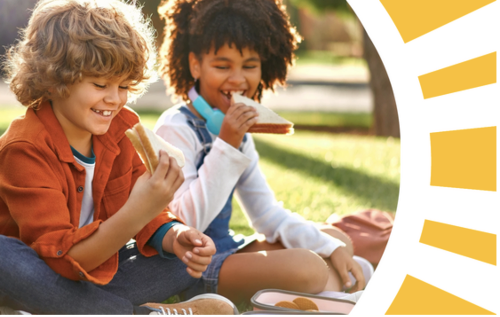 Two children eating lunch outdoors