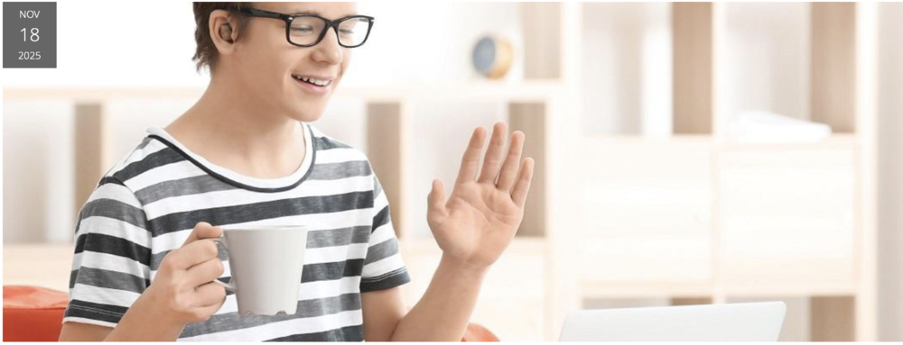 Student with mug waving hi.