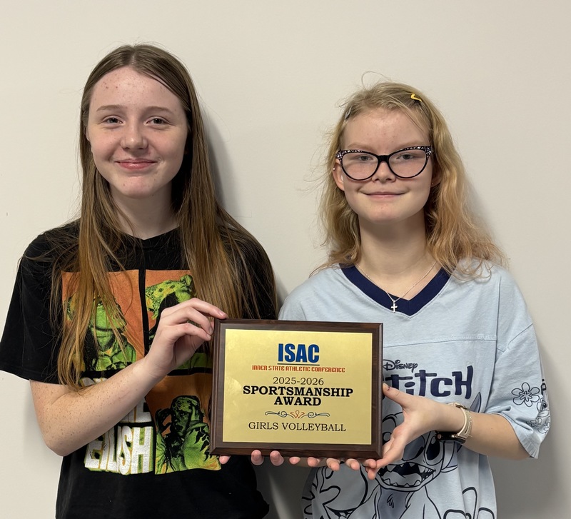 two team members holding award