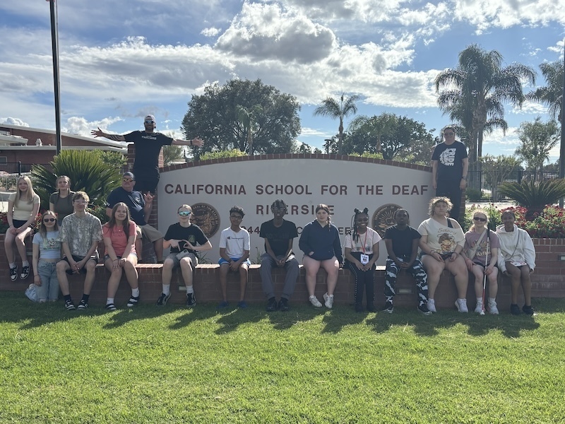 The team in front of the CSD-Riverside sign
