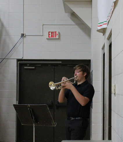 Junior band member playing taps