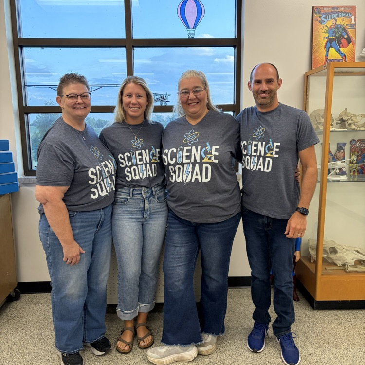 four science teachers wearing matching shirts that say “science squad"