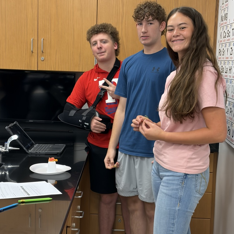 three students at science lab station