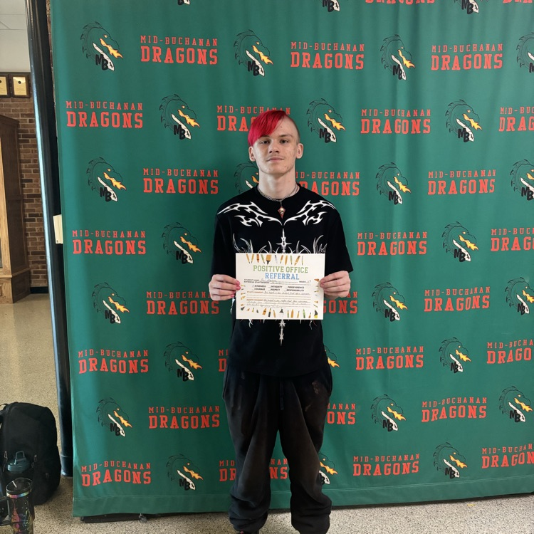 boy holding a certificate with a green background