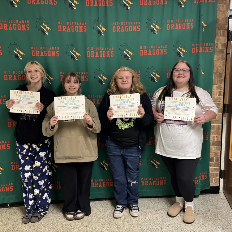 4 girls holding certificates in front of a green background