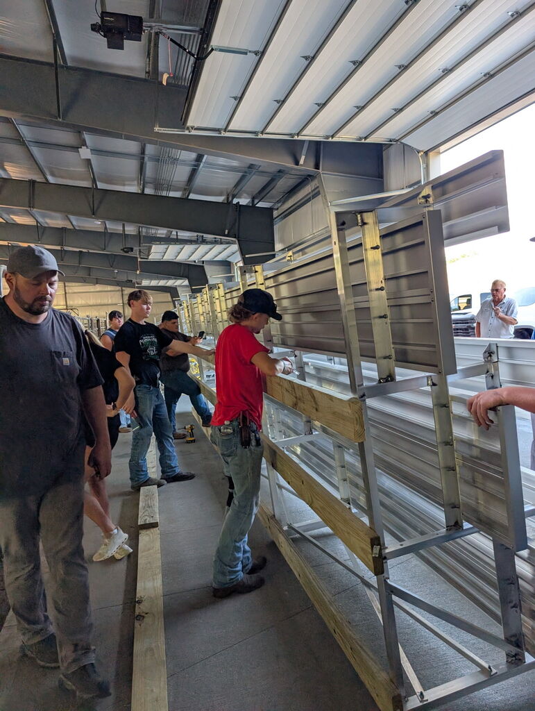 Students working to build metal bleachers