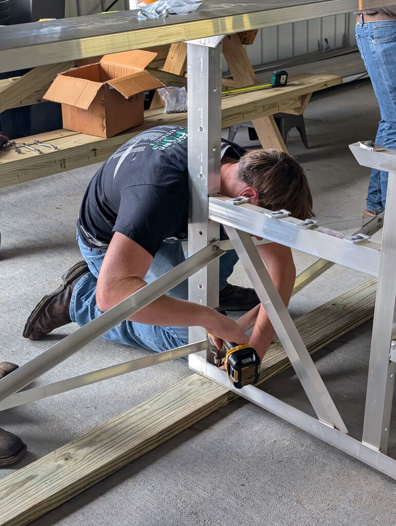 Students working to build metal bleachers