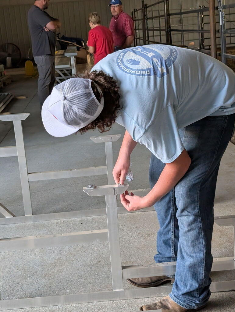 Students working to build metal bleachers