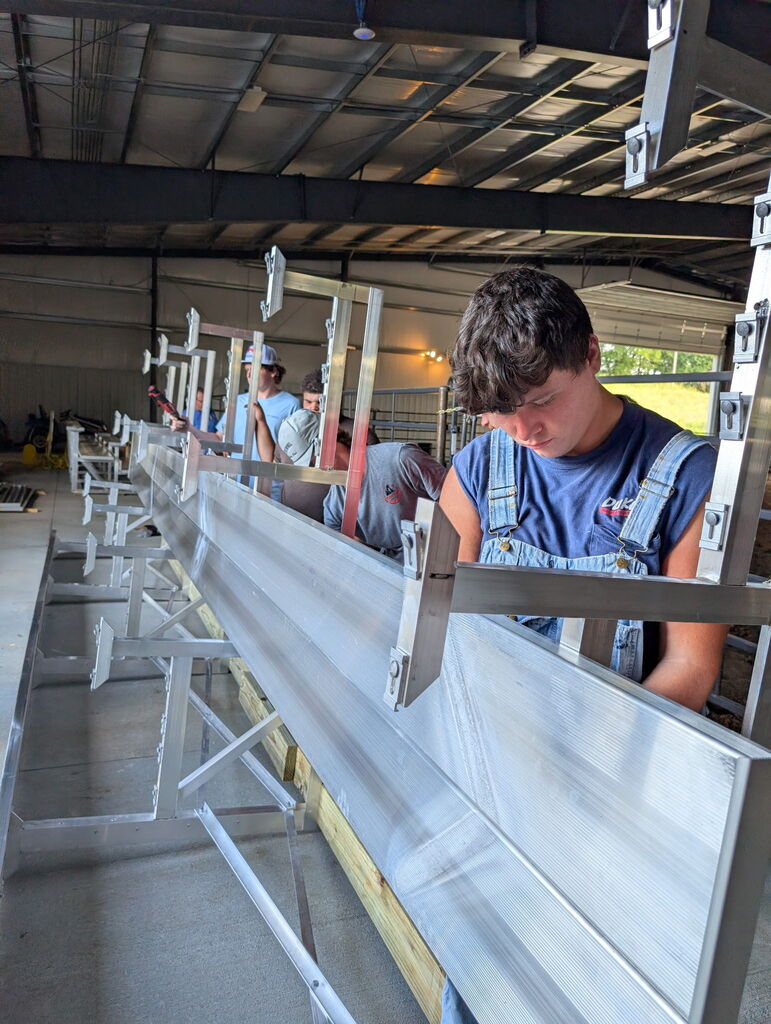 Students working to build metal bleachers