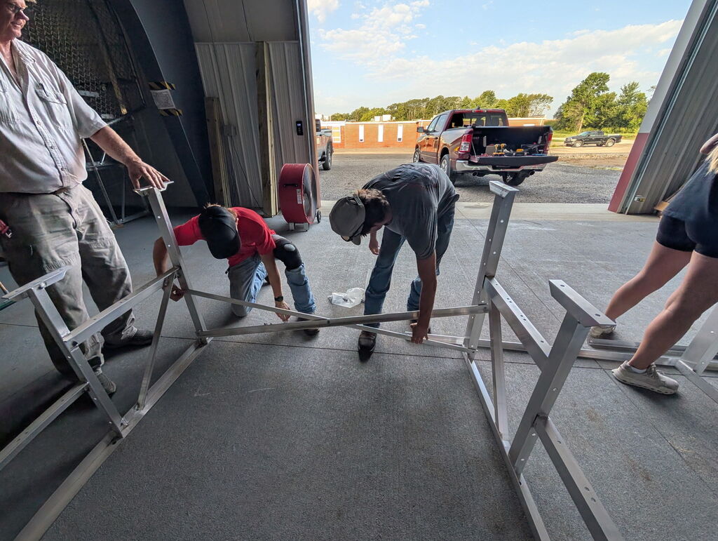 Students working to build metal bleachers