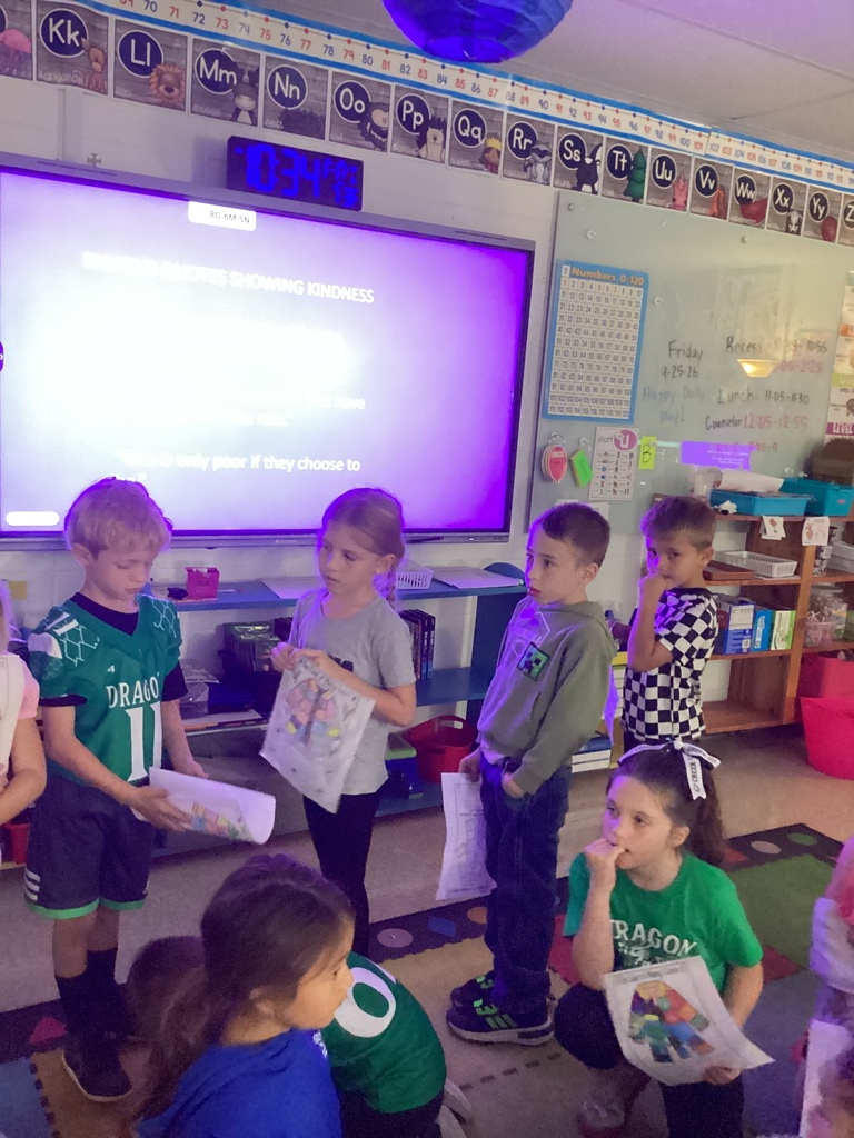 Students holding pictures with the coat of many colors