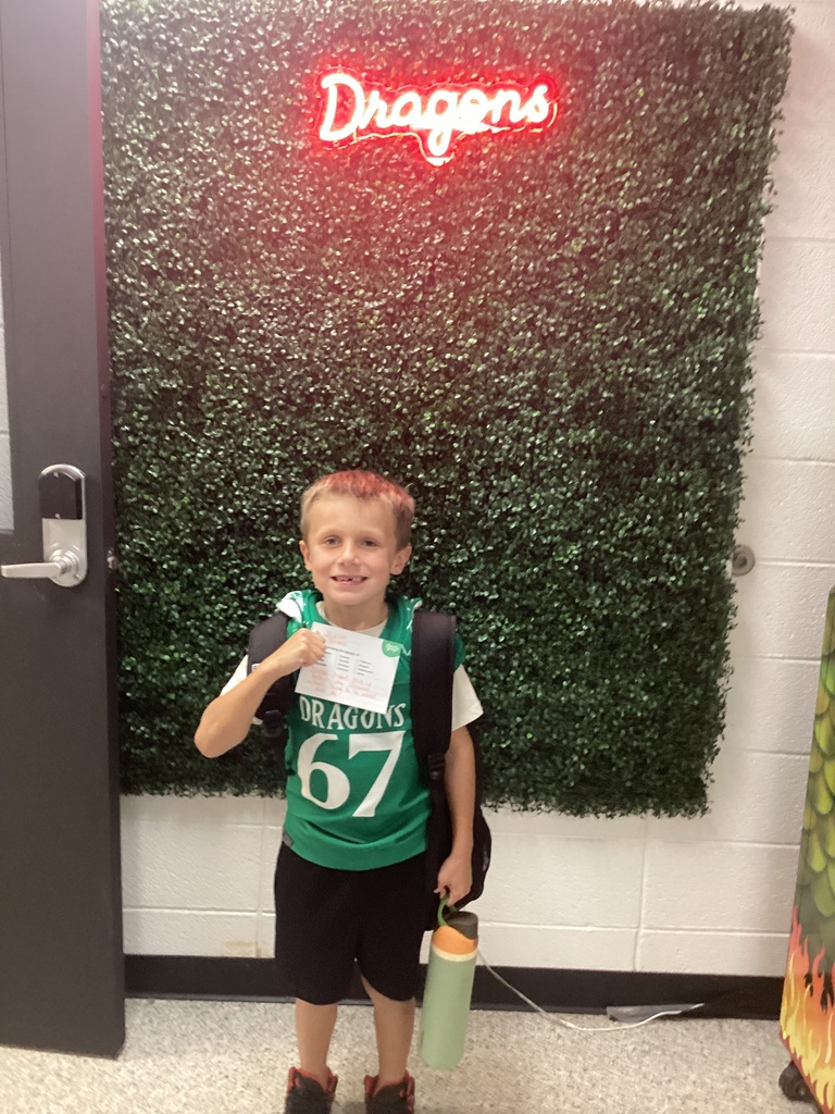 A boy holding his award
