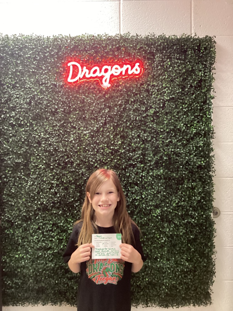 A girl holding her award