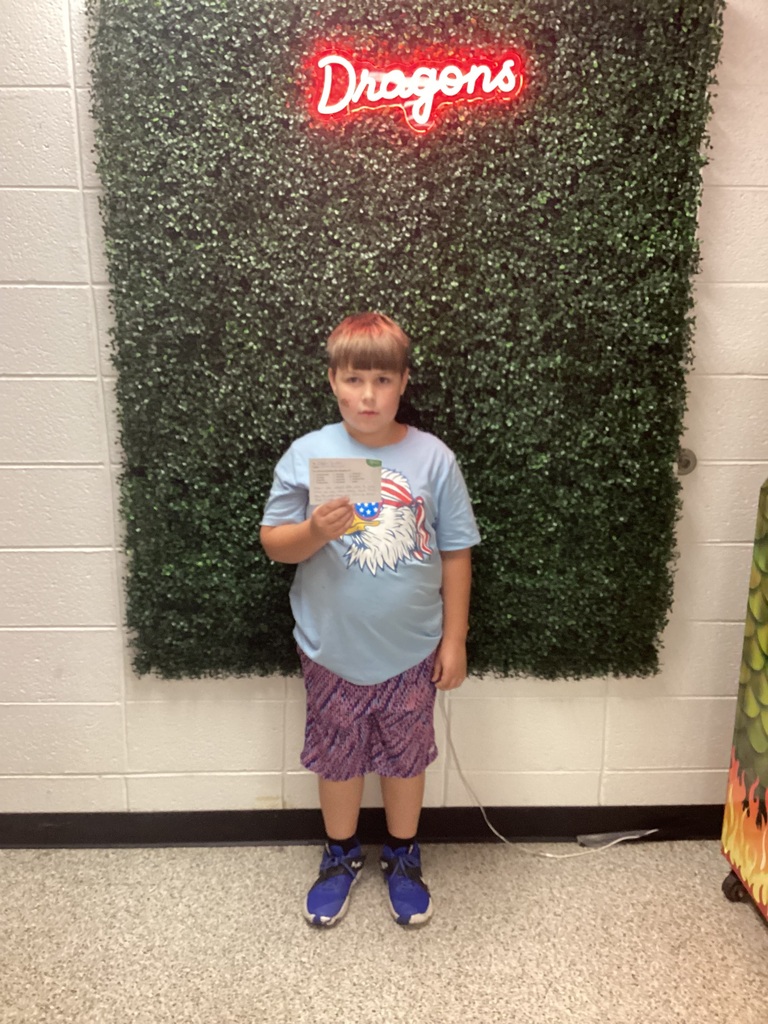A boy holding his award