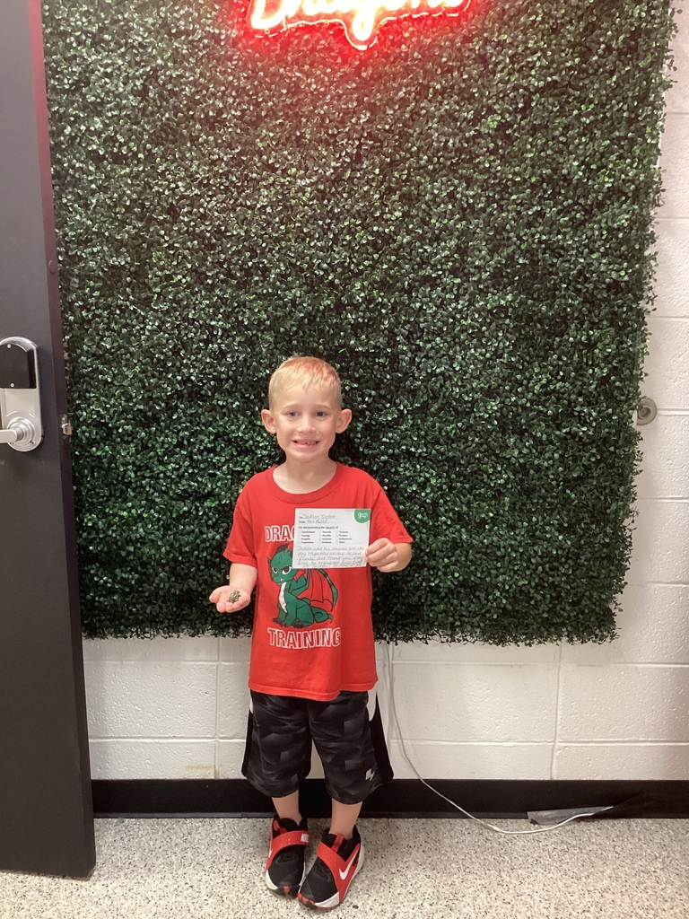A boy holding his award