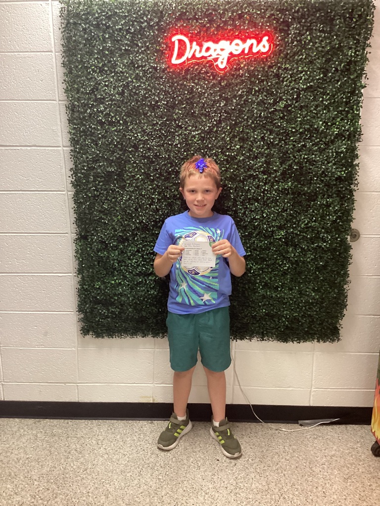 A boy holding his award