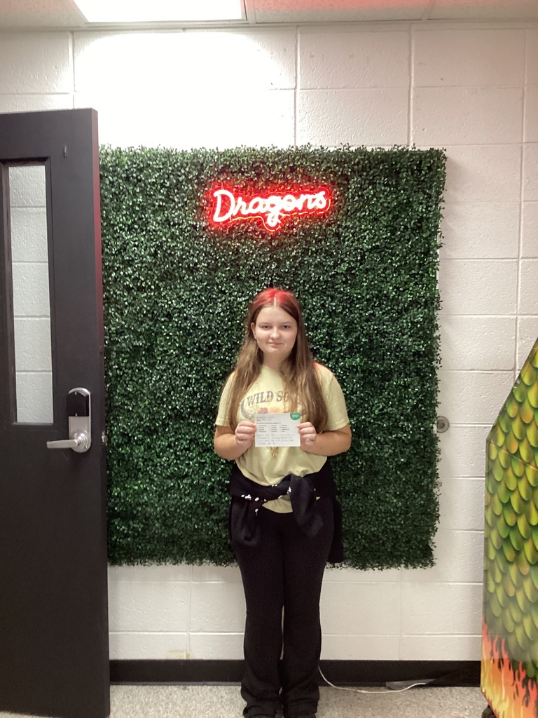 A girl holding her award