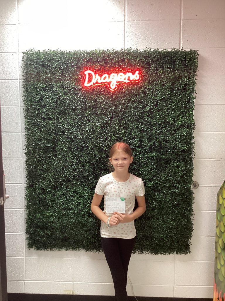 A girl holding her award