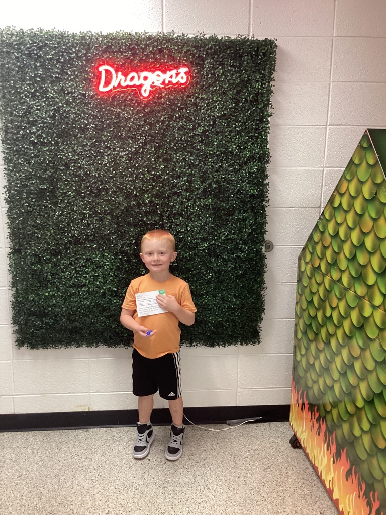 A boy holding his award