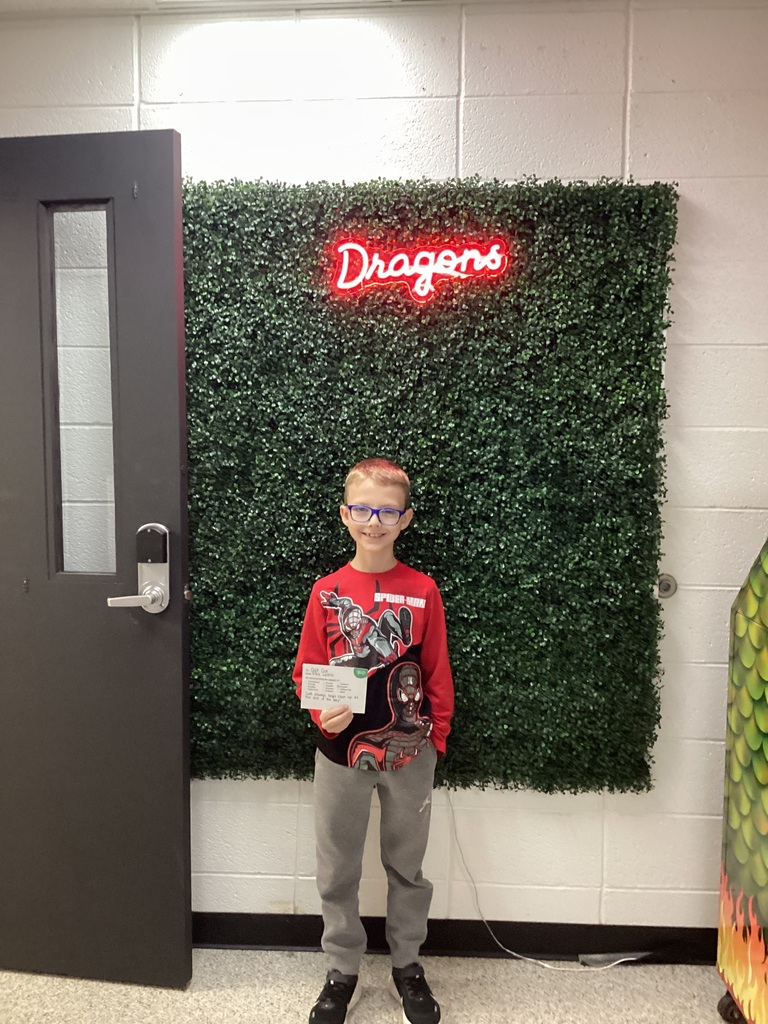 A boy his holding his award