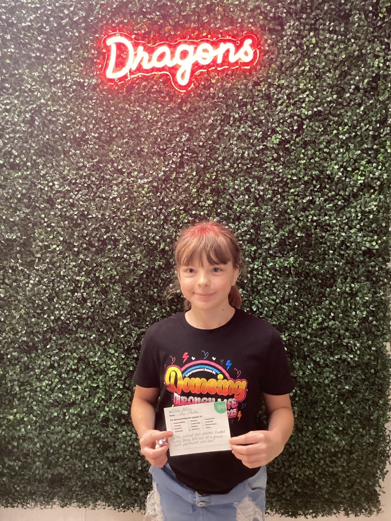 A girl holding her award