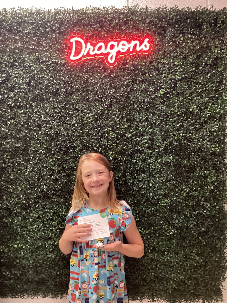 A girl holding her award