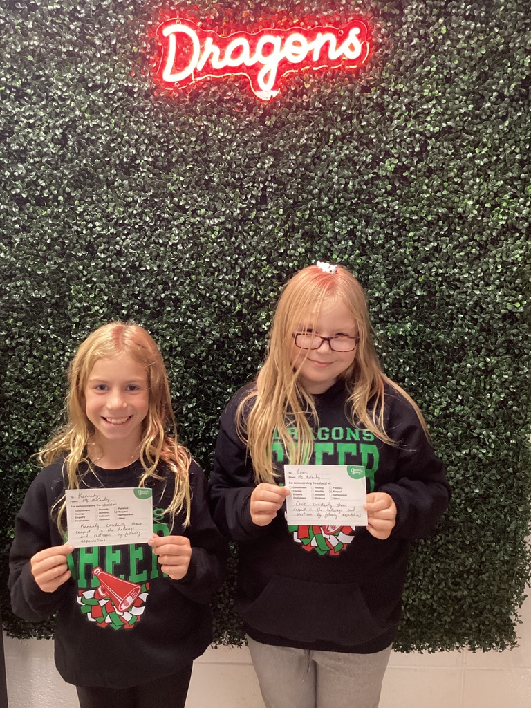 2 girls holding their award