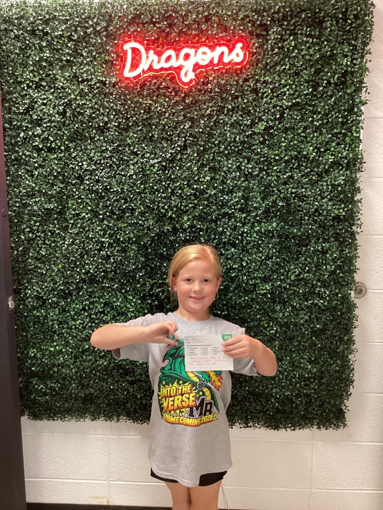 A girl holding her award
