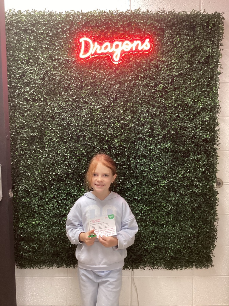A girl holding her award