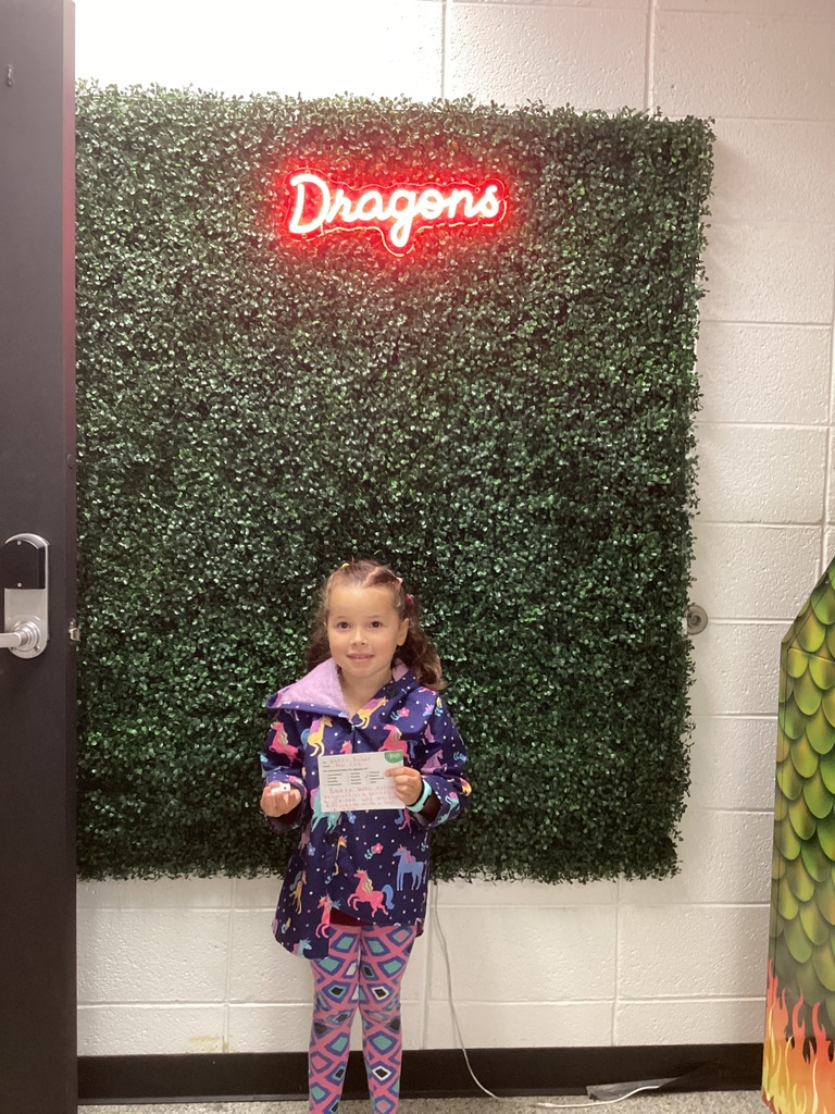 A girl holding her award