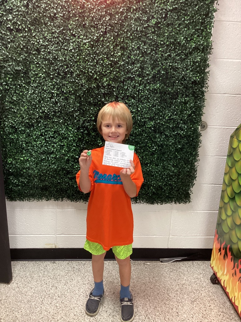 A boy holding his award