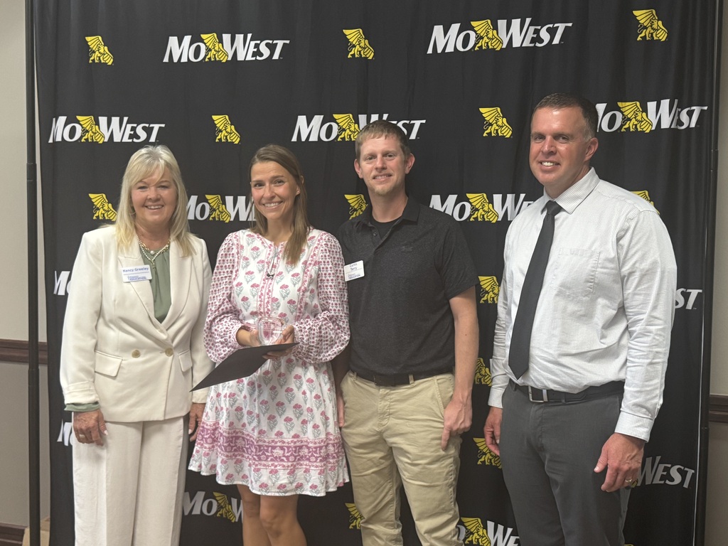 Melanie Vulgamott receiving her award from state and regional leaders