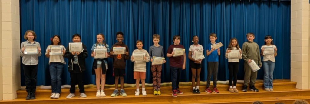 Image of students with their honor roll awards.