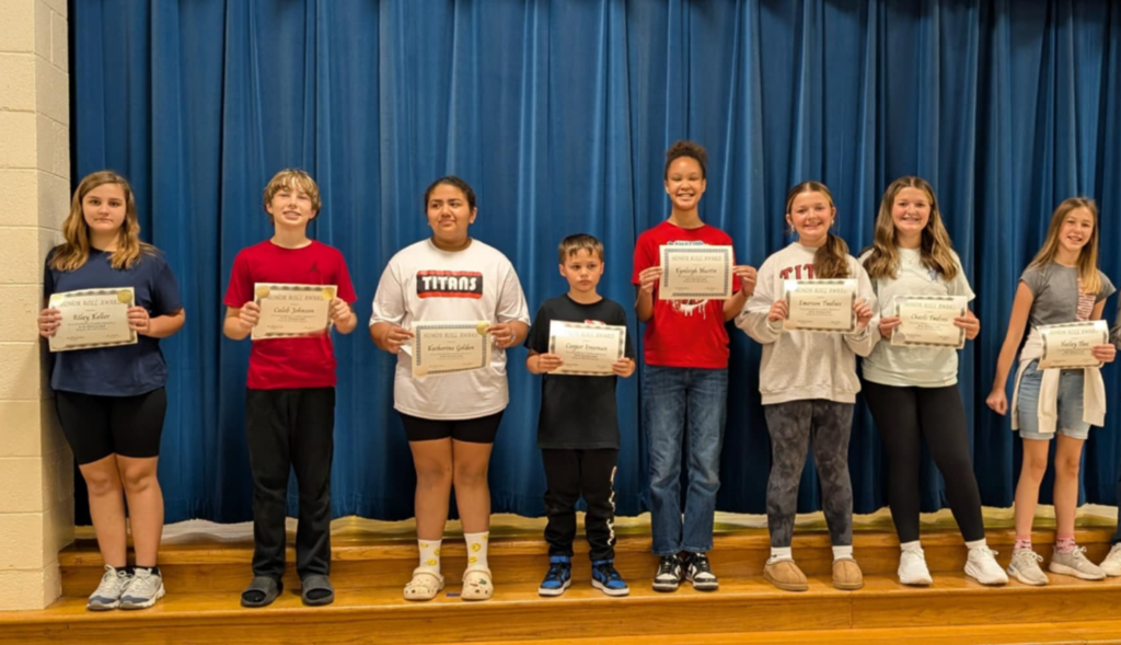Image of students with their honor roll awards.