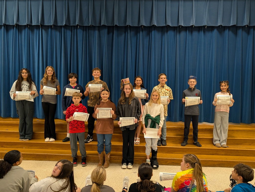 Image of students with their honor roll awards.