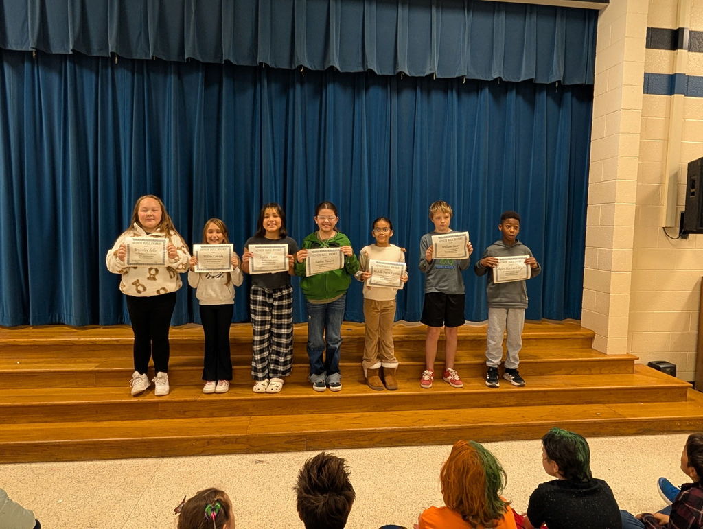 Image of students with their honor roll awards.