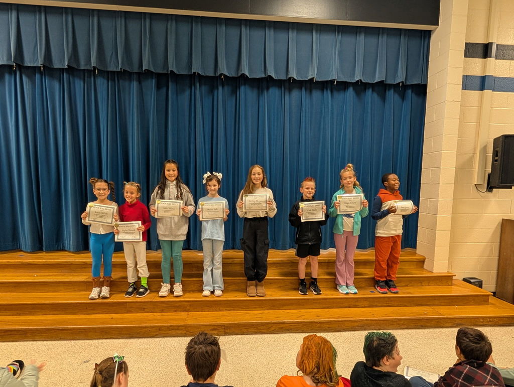 Image of students with their honor roll awards.