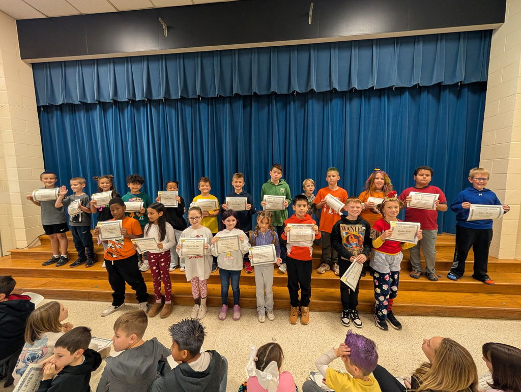 Image of students with their honor roll awards.