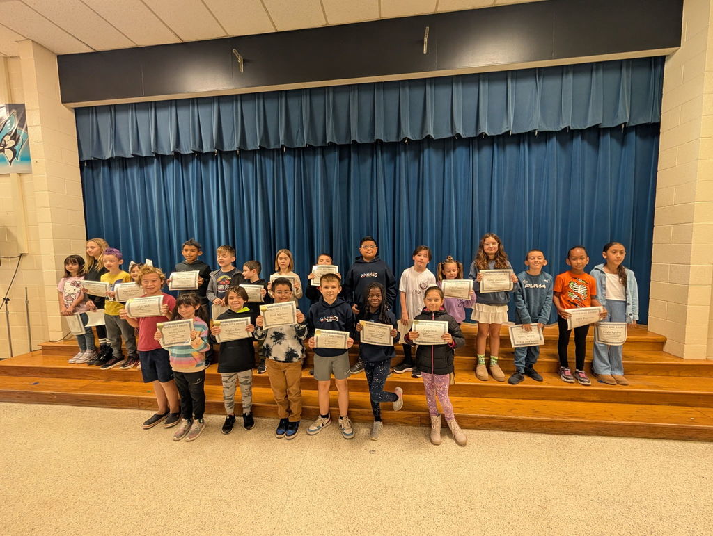 Image of students with their honor roll awards.