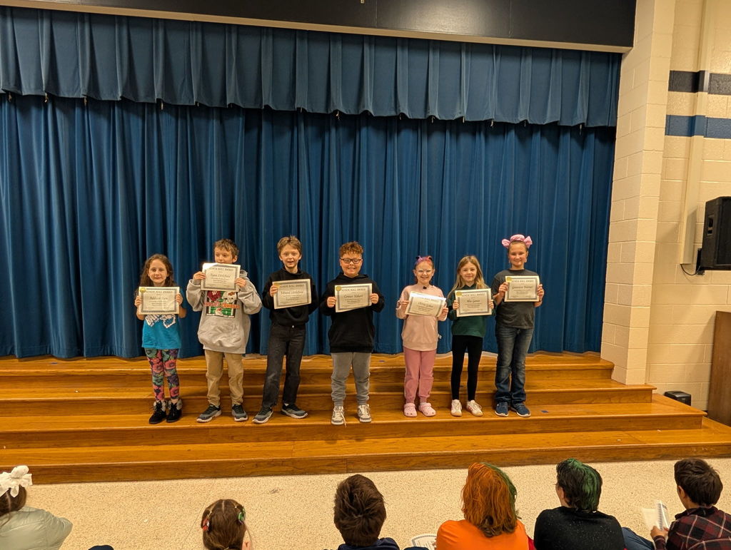 Image of students with their honor roll awards.