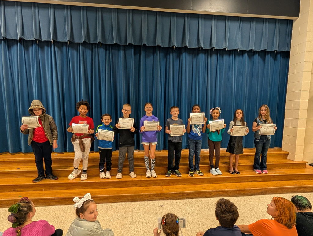 Image of students with their honor roll awards.