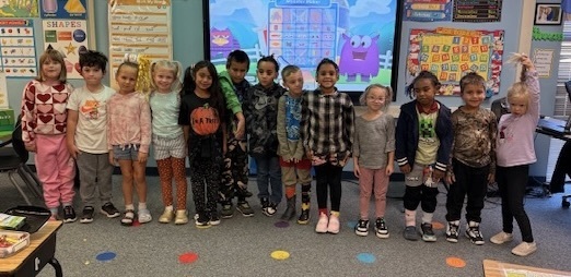 Image of students and staff dressed with crazy clothes and hair.