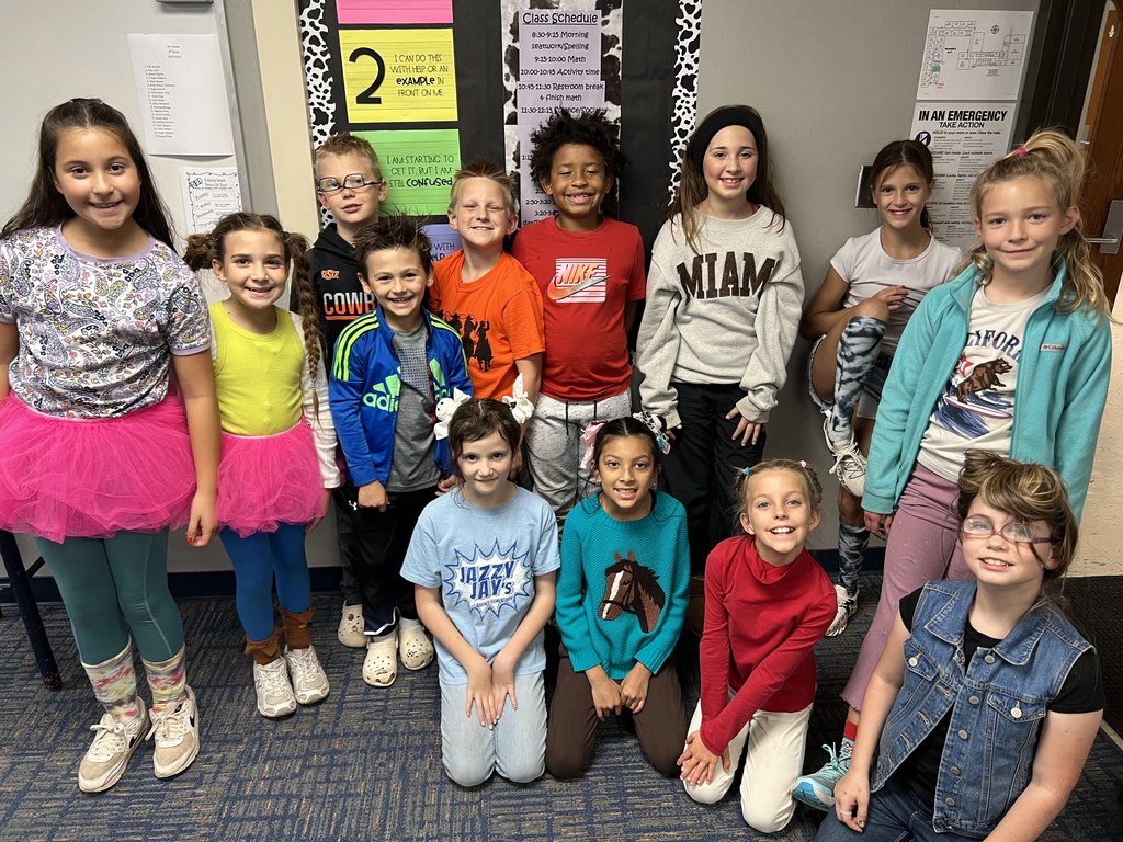 Image of students and staff dressed with crazy clothes and hair.