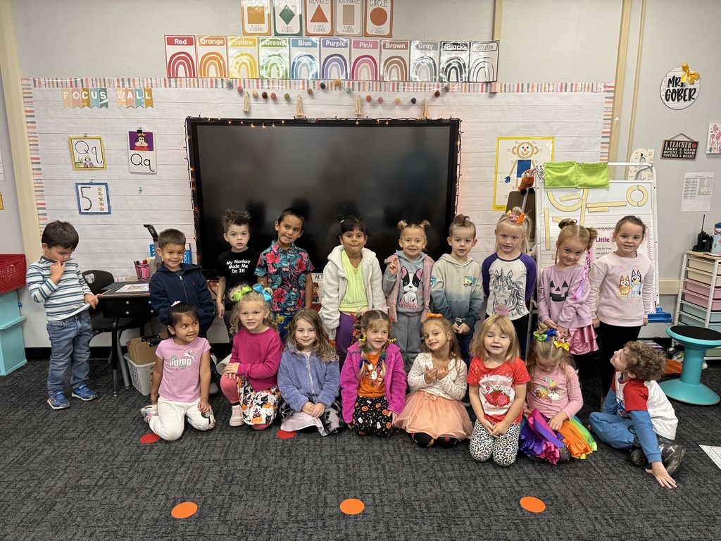 Image of students and staff dressed with crazy clothes and hair.