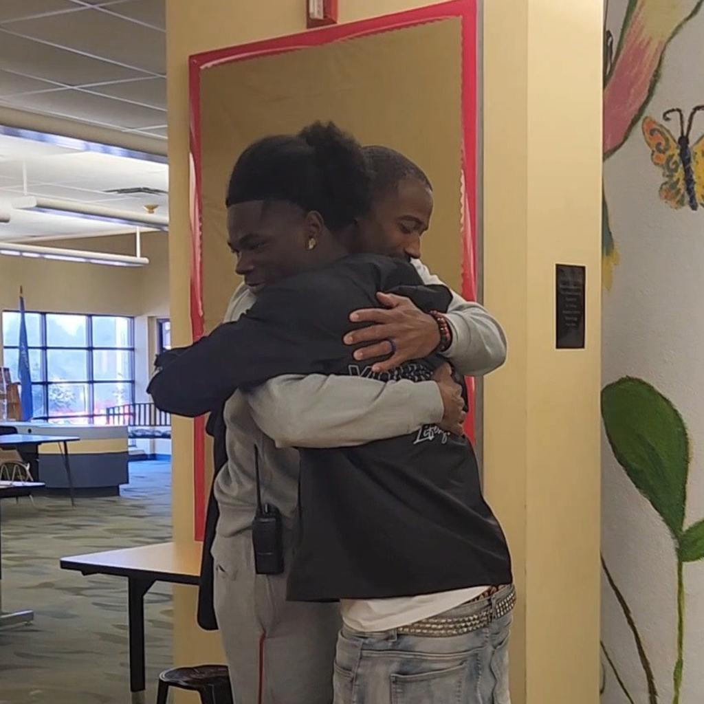 Mr. Hawkins and Tavion McGuire hugging