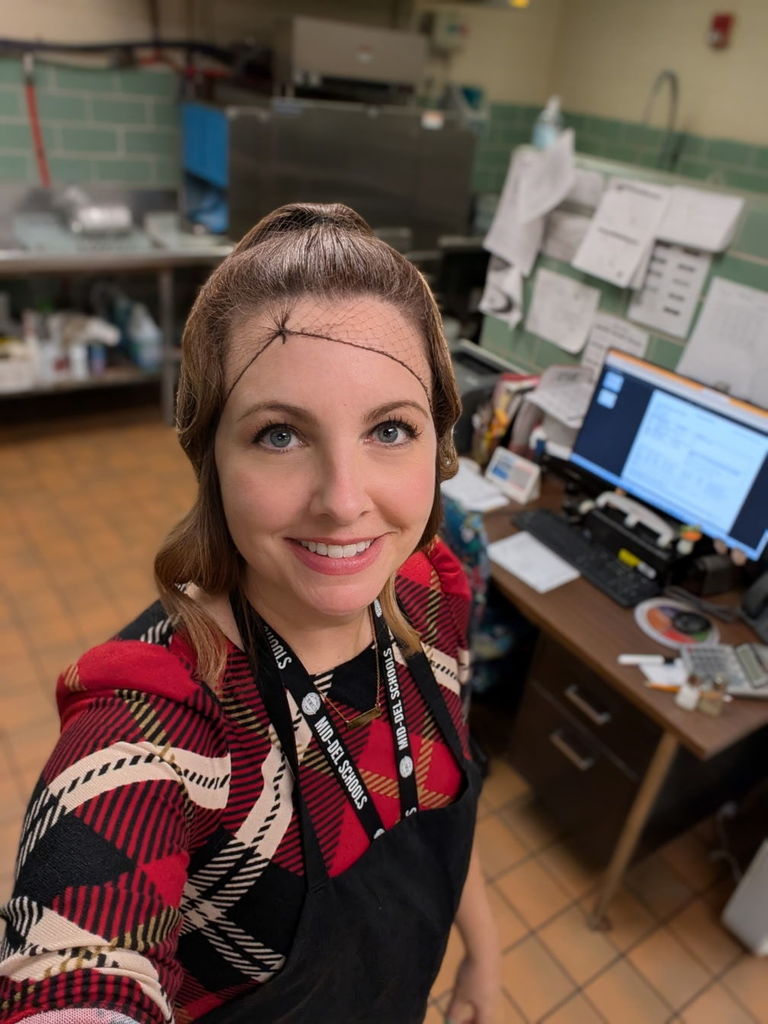 Mrs. Paris serving food in the cafeteria.