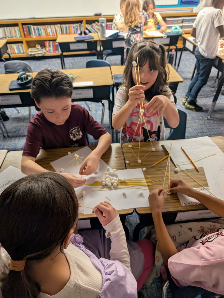 Image of third graders working together on a project.