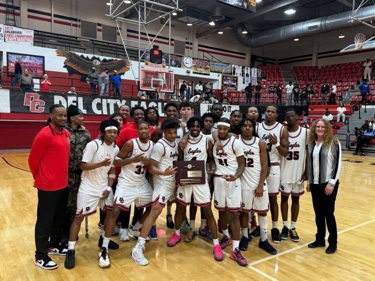 Del City Boys won Basketball Regionals. The team is holding the Regional Champiion plaque.