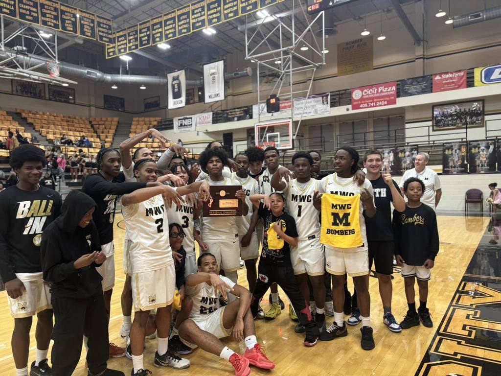 Midwest City Boys won Basketball Regionals. The team is holding the Regional Champiion plaque.